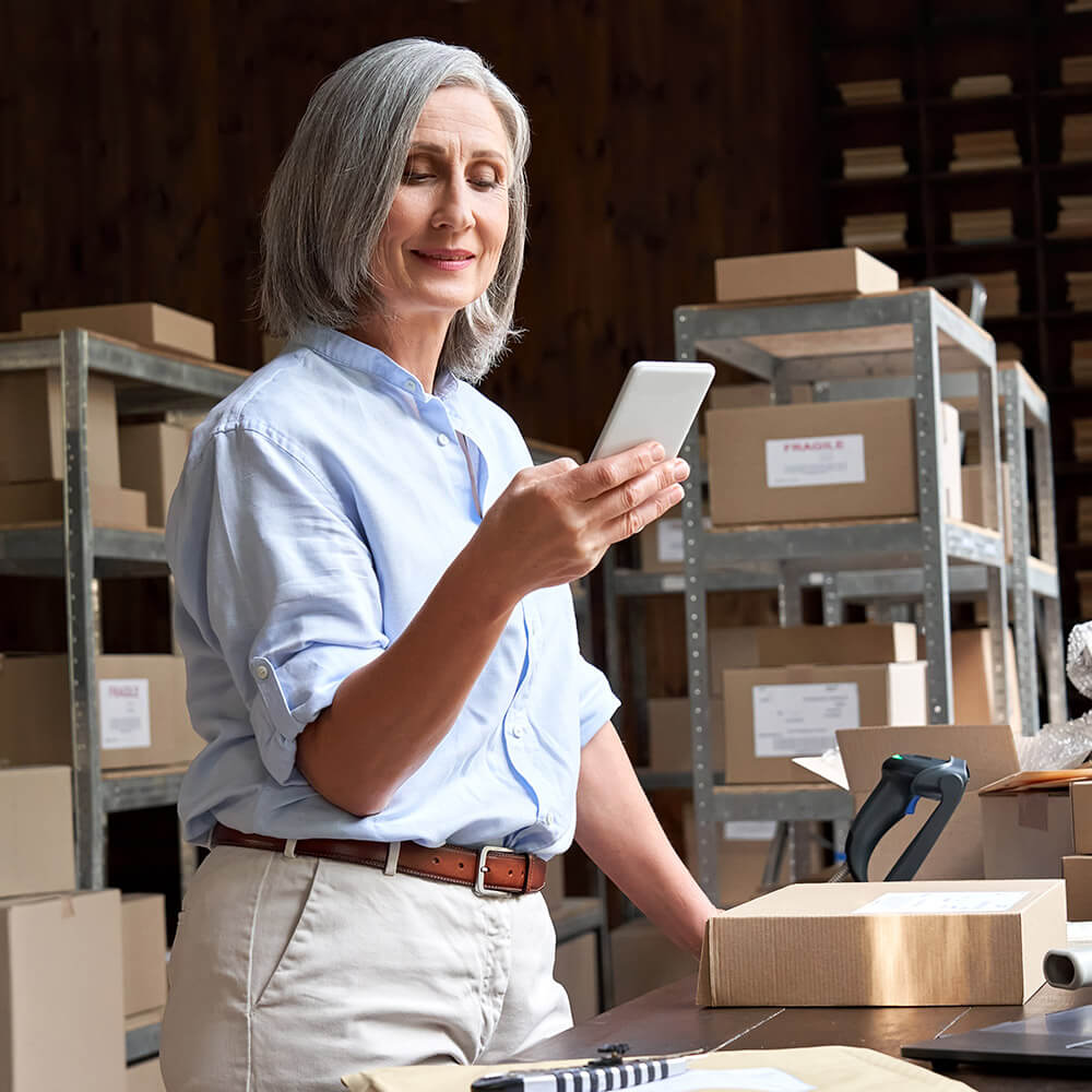 Female business owner using mobile app checking parcel box