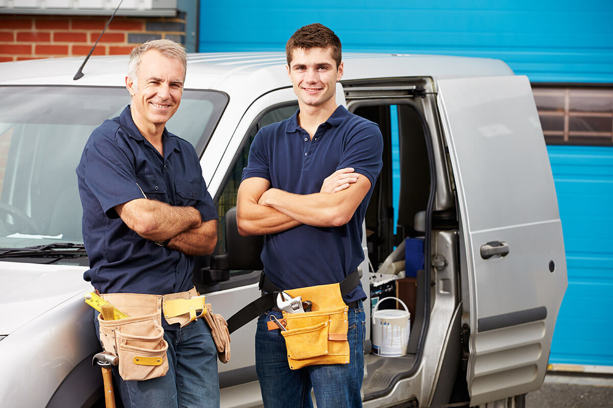 workers In family business standing next to a van